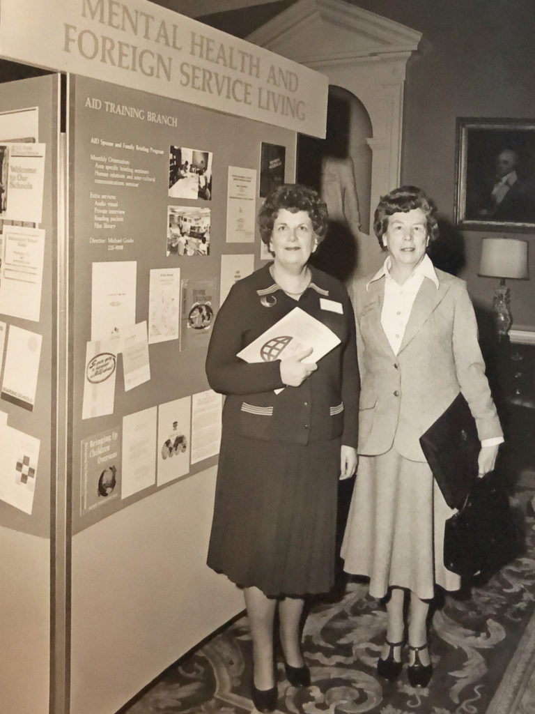 Two women standing next to the information display that was created to accompany the Mental Health Panel on March 14, 1978.