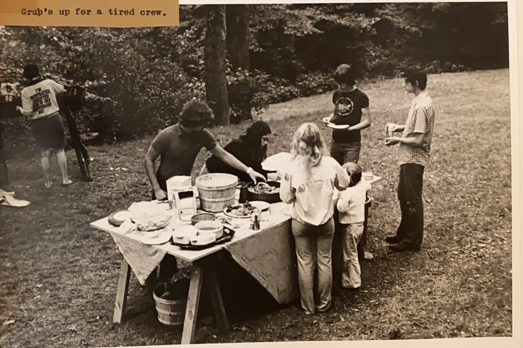 Young people standing around a picnic table in 1975